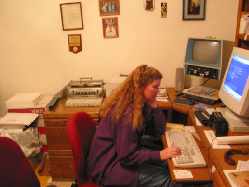 Janice working at her computer in her office.