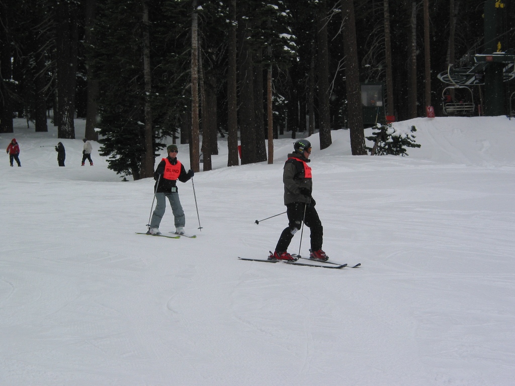 Janice snow skiing with her guide, Jeff.